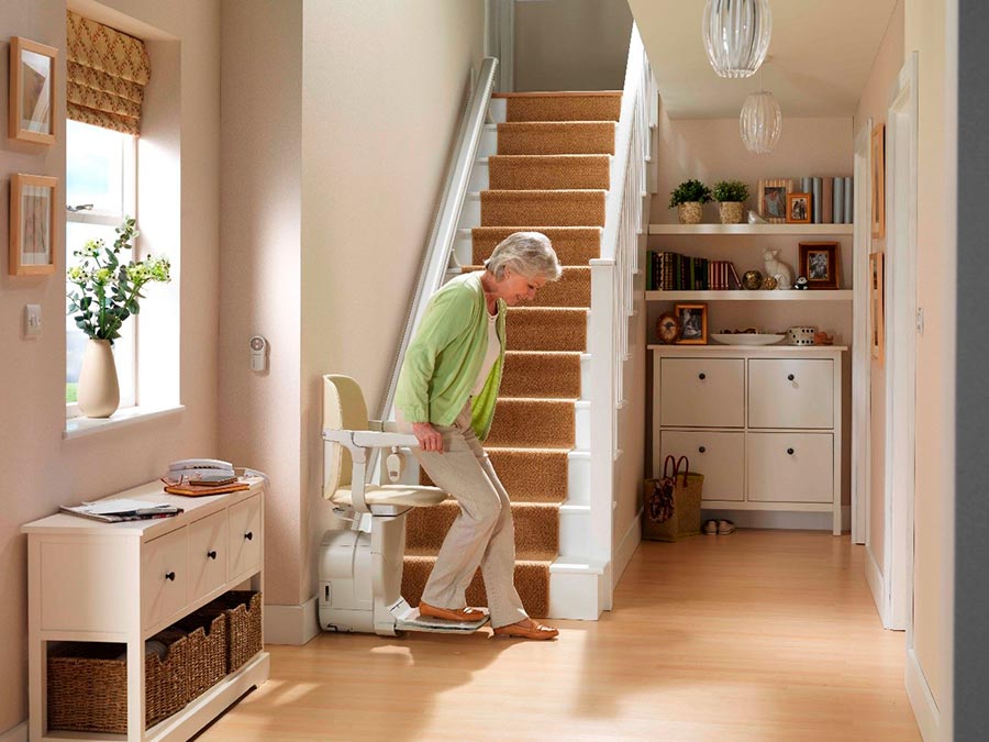Elderly person sitting on a stairlift