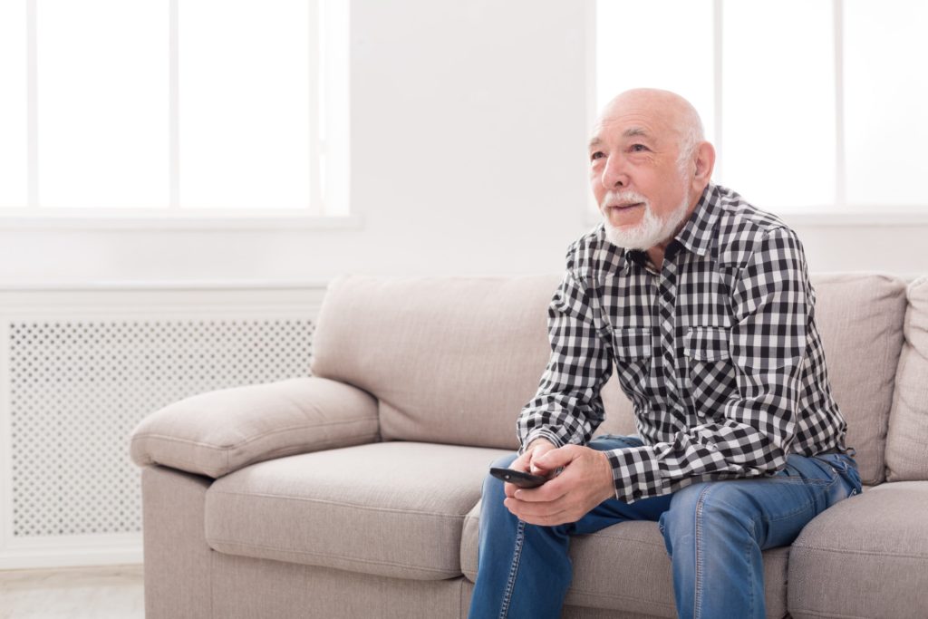 older man watching television